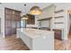 Gourmet kitchen island with seating, marble countertops, custom cabinetry, and pendant lighting at 8083 Easton Ln, Zionsville, IN 46077