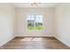 Bright room with hardwood floors and a large window offering a view at 8083 Easton Ln, Zionsville, IN 46077