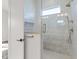 Modern shower with neutral colored tile, a glass door, and a built-in niche for storage at 8083 Easton Ln, Zionsville, IN 46077