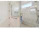 Modern shower with sleek fixtures, textured tile, and glass door at 8083 Easton Ln, Zionsville, IN 46077