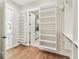 Large walk-in closet with custom shelving, leading to the bathroom and kitchen at 8083 Easton Ln, Zionsville, IN 46077