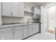 The utility room features gray cabinets, a countertop, a sink, and gold hardware at 8083 Easton Ln, Zionsville, IN 46077