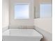 Bathroom featuring a modern freestanding tub, neutral tile, and contemporary fixtures at 8083 Easton Ln, Zionsville, IN 46077