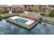 An aerial view of a unique community pool house situated on a pond with beautiful surrounding buildings at 8651 Jaffa Court East Dr # 18, Indianapolis, IN 46260