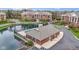 Overhead shot of a community pool house on a pond surrounded by buildings, and colorful flowering trees at 8651 Jaffa Court East Dr # 18, Indianapolis, IN 46260
