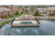 Aerial view showcasing a community pool house set in the middle of a pond at 8651 Jaffa Court East Dr # 18, Indianapolis, IN 46260