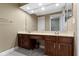 Bathroom featuring dual sinks, wood cabinets and a decorative mirror at 8651 Jaffa Court East Dr # 18, Indianapolis, IN 46260