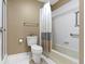 Bright bathroom featuring a bathtub and shower combination, a toilet, and updated fixtures at 8651 Jaffa Court East Dr # 18, Indianapolis, IN 46260