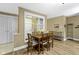 Cozy dining area with a wooden table set, neutral walls, and views into other rooms at 8651 Jaffa Court East Dr # 18, Indianapolis, IN 46260
