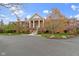 Brick building with a stately entrance featuring prominent columns and well-maintained landscaping at 8651 Jaffa Court East Dr # 18, Indianapolis, IN 46260