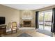Corner of the living room featuring a fireplace, sliding doors to the deck, and neutral colors at 8651 Jaffa Court East Dr # 18, Indianapolis, IN 46260