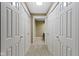 Hallway with closet and a glimpse into a bathroom with granite countertops at 8651 Jaffa Court East Dr # 18, Indianapolis, IN 46260