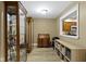 Hallway with hardwood floors, cabinets, desk and natural lighting from nearby window at 8651 Jaffa Court East Dr # 18, Indianapolis, IN 46260
