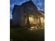 Side view of a two-story home featuring a covered porch with seating and a well-maintained yard at dusk at 912 Grassy Branch Dr, Indianapolis, IN 46239