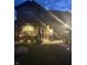 Charming two-story home with a well-manicured lawn, covered porch, and a cozy seating area at twilight at 912 Grassy Branch Dr, Indianapolis, IN 46239
