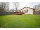 Private backyard featuring a wooden deck, privacy fence, and a lush green lawn offering endless outdoor possibilities at 9143 Warwick Rd, Indianapolis, IN 46240