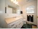 Bathroom featuring a large mirror, a white vanity, and green tile flooring at 9143 Warwick Rd, Indianapolis, IN 46240