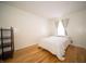 Bedroom featuring hardwood flooring, a small bed, and a large window at 9143 Warwick Rd, Indianapolis, IN 46240