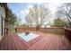 Spacious wooden deck with a fire pit, cozy seating area, and views of the backyard perfect for outdoor enjoyment at 9143 Warwick Rd, Indianapolis, IN 46240