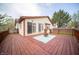 Relax on the expansive wooden deck featuring sliding glass doors, a cozy seating area, and views of the backyard at 9143 Warwick Rd, Indianapolis, IN 46240