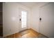 Bright entryway with a front door with glass, wood-look floors, and a convenient coat closet at 9143 Warwick Rd, Indianapolis, IN 46240