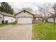 Charming home featuring a well-maintained lawn, neutral siding, brick accents, and an attached two-car garage at 9143 Warwick Rd, Indianapolis, IN 46240