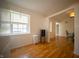 Open kitchen area with wood floors, a window, and modern appliances at 9143 Warwick Rd, Indianapolis, IN 46240