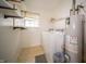 Bright laundry room with washer, dryer, water heater and shelving at 9143 Warwick Rd, Indianapolis, IN 46240