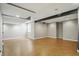 Unfinished basement with high ceilings, exposed beams, and concrete floors, offering potential for customization at 9318 Windrift Way, Zionsville, IN 46077