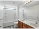Bright bathroom features a double sink vanity and shower over tub combination at 9318 Windrift Way, Zionsville, IN 46077