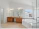 Bathroom boasts a double vanity, soaking tub, window and separate shower, perfect for relaxation and convenience at 9318 Windrift Way, Zionsville, IN 46077