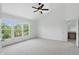 Spacious bedroom with neutral carpet, large windows, and ceiling fan for a comfortable and airy feel at 9318 Windrift Way, Zionsville, IN 46077