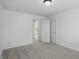 Simple bedroom featuring neutral carpet, closet, and entry door at 9318 Windrift Way, Zionsville, IN 46077