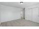 Simple bedroom featuring plush neutral carpet, closet, and entry door at 9318 Windrift Way, Zionsville, IN 46077