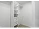 A walk-in closet with custom built-in shelving, offering ample and organized storage solutions at 9318 Windrift Way, Zionsville, IN 46077