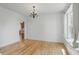 Bright empty room with hardwood floors, neutral walls, and natural light from a window at 9318 Windrift Way, Zionsville, IN 46077
