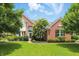Charming two-story brick home with a manicured lawn and mature trees, creating a welcoming curb appeal at 9318 Windrift Way, Zionsville, IN 46077