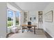 Well-lit home office with built-in shelving, a comfortable workspace, and a large window providing natural light at 9318 Windrift Way, Zionsville, IN 46077