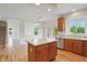 Kitchen with light wood floors, stainless steel appliances, and an island at 9318 Windrift Way, Zionsville, IN 46077