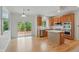 Kitchen with stainless appliances and wooden cabinets leading to the outdoor deck at 9318 Windrift Way, Zionsville, IN 46077