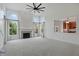 Living room with fireplace, high ceilings, many windows and adjoined kitchen at 9318 Windrift Way, Zionsville, IN 46077