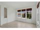 Bright living room with large windows and neutral tile floors showcases a light-filled space at 9318 Windrift Way, Zionsville, IN 46077