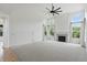 Bright living room featuring high ceilings, large windows, fireplace and modern ceiling fan at 9318 Windrift Way, Zionsville, IN 46077