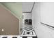 Lower level with view of a dining table, checkerboard flooring, and white brick-like walls at 933 Hummingbird Ln, Columbus, IN 47203