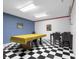 Basement game room featuring a pool table, seating, and adjacent dining area at 933 Hummingbird Ln, Columbus, IN 47203