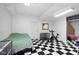 Finished basement area showing exercise equipment, adjacent to an open space at 933 Hummingbird Ln, Columbus, IN 47203