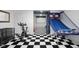 Recreational basement area with gym equipment, a basketball hoop, and black and white flooring at 933 Hummingbird Ln, Columbus, IN 47203