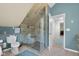 A luxurious bathroom showcasing a glass shower enclosure, toilet, tile floor, and a door leading to another room at 933 Hummingbird Ln, Columbus, IN 47203