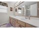A bathroom with natural cabinets, solid surface counters, modern fixtures, a large mirror, and a walk-in shower at 933 Hummingbird Ln, Columbus, IN 47203