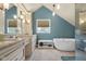 A spacious bathroom featuring an extended vanity, neutral paint, granite counters, tile floor and a freestanding bathtub at 933 Hummingbird Ln, Columbus, IN 47203
